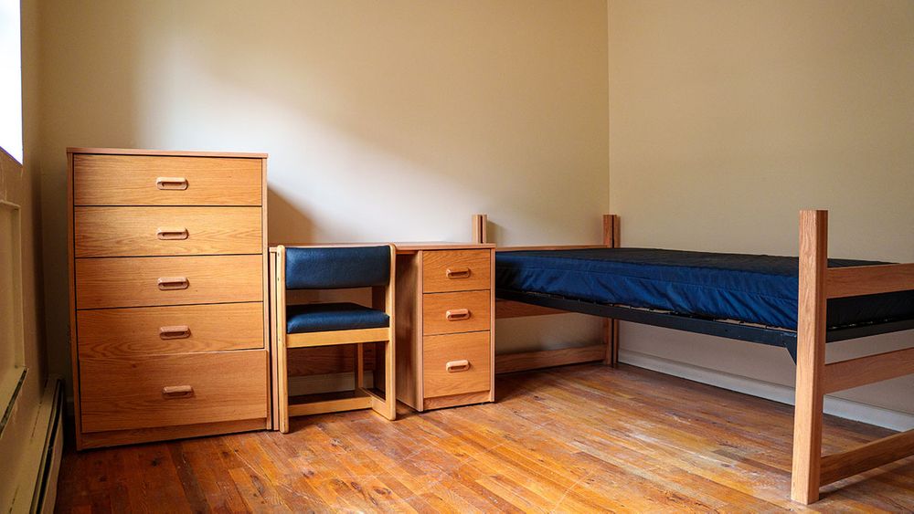 Example of a bed, desk and dresser set up in a not yet decorated bedroom