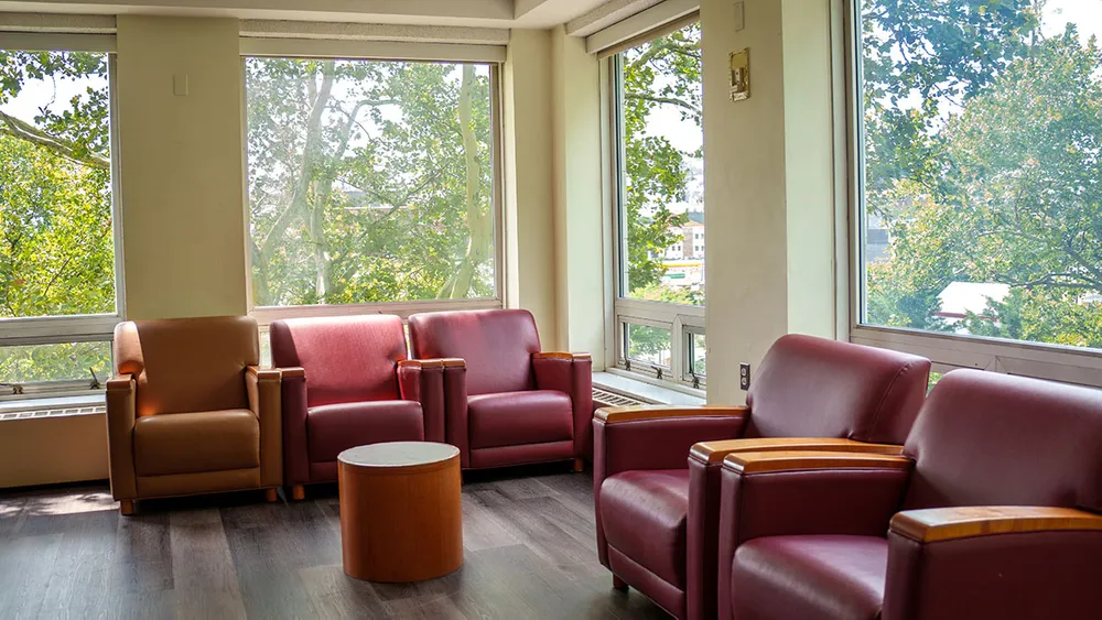 Study nook with lounge chairs and large windows with natural light