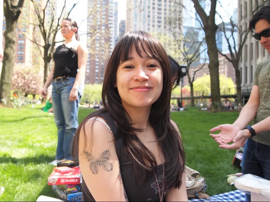 A student sitting outside in Bryant Park