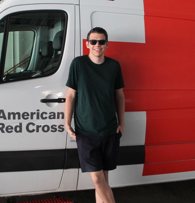 Image of Student in front of a Red Cross Van