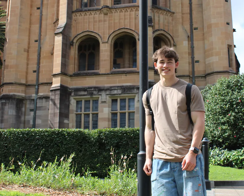 Student standing in front of a building