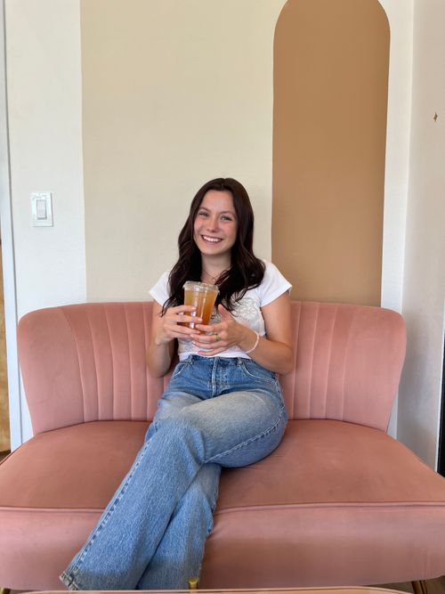 Student sitting on a pink chair