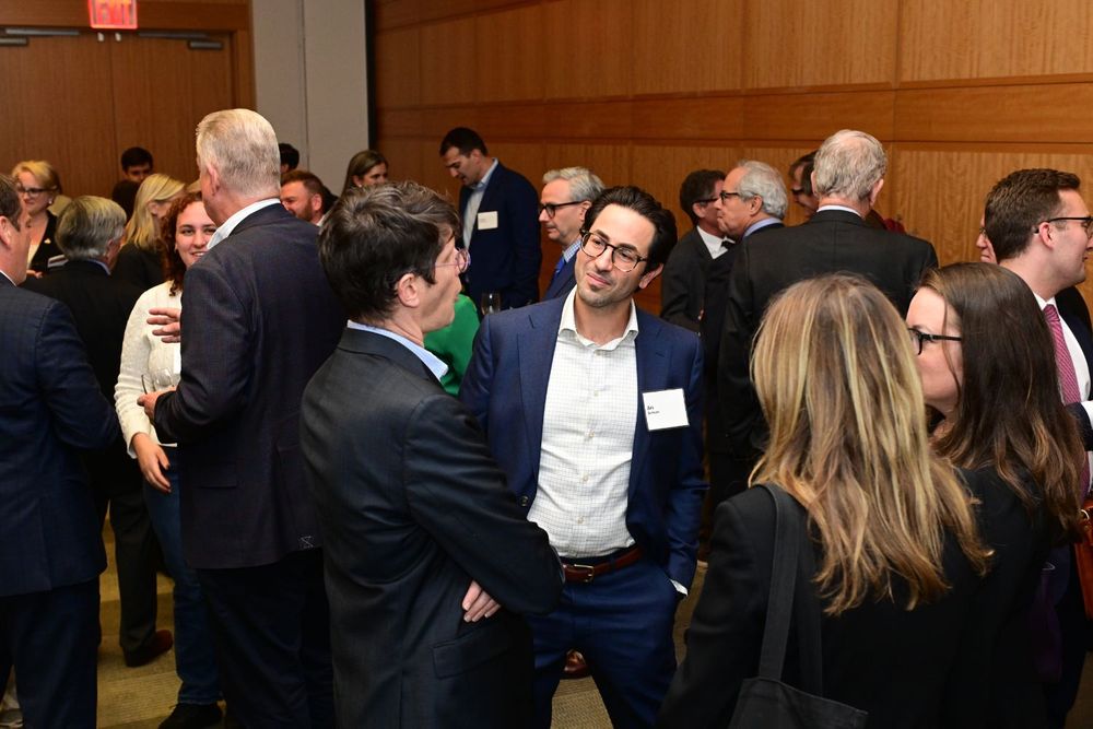 Ari Seiman chats with guests at reception Fordham Law Sommer Lecture 2024