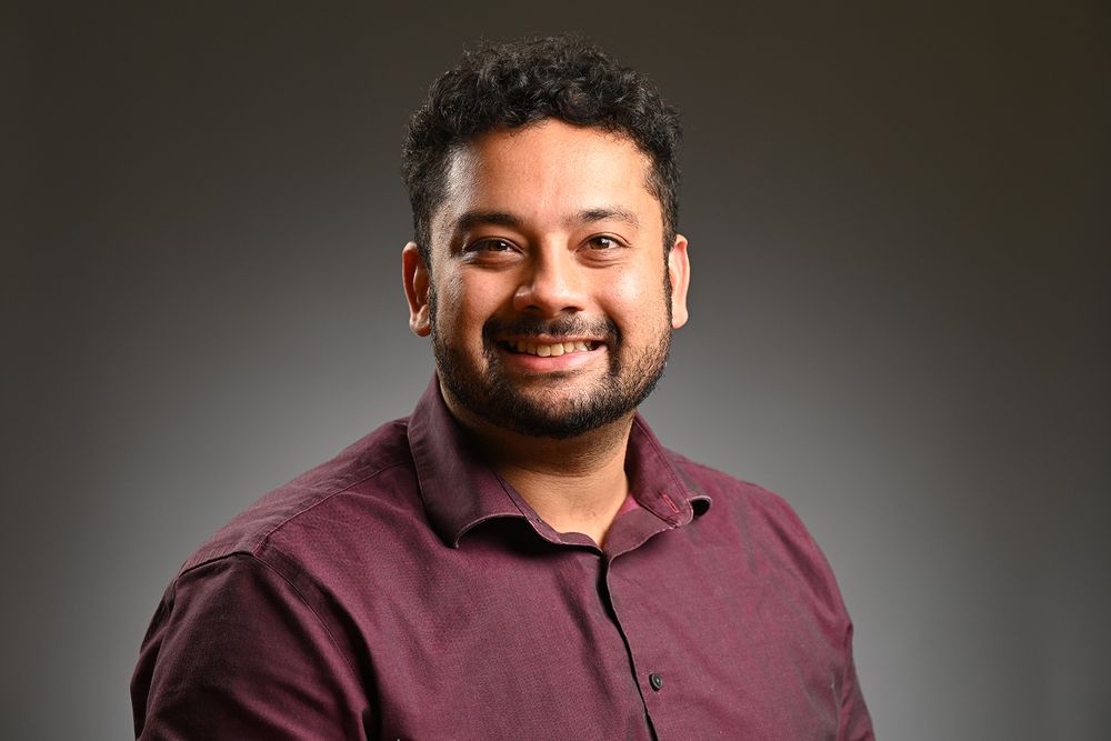 A man wearing a maroon shirt.