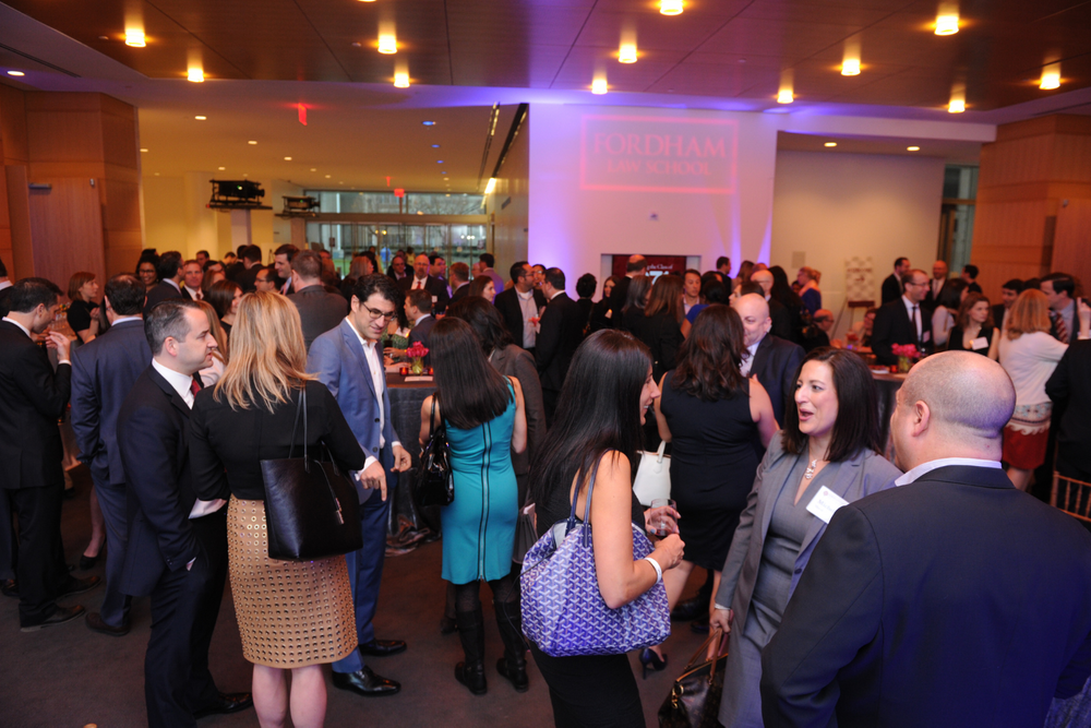 Crowd chatting at Reunion Fordham Law