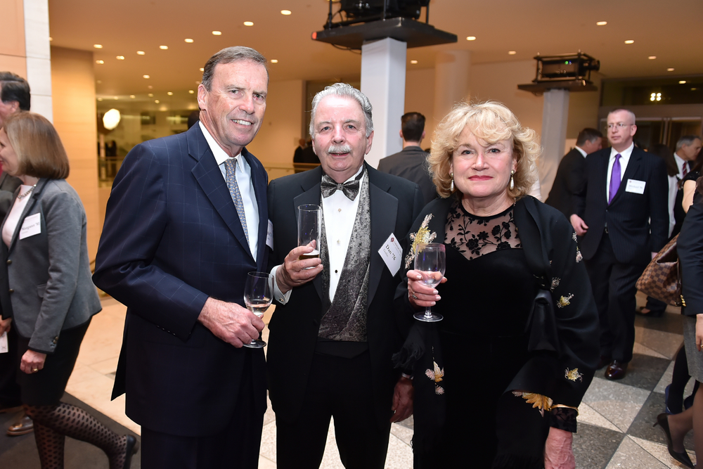 Alumni in suit and tie cheers Class 76 Fordham Law