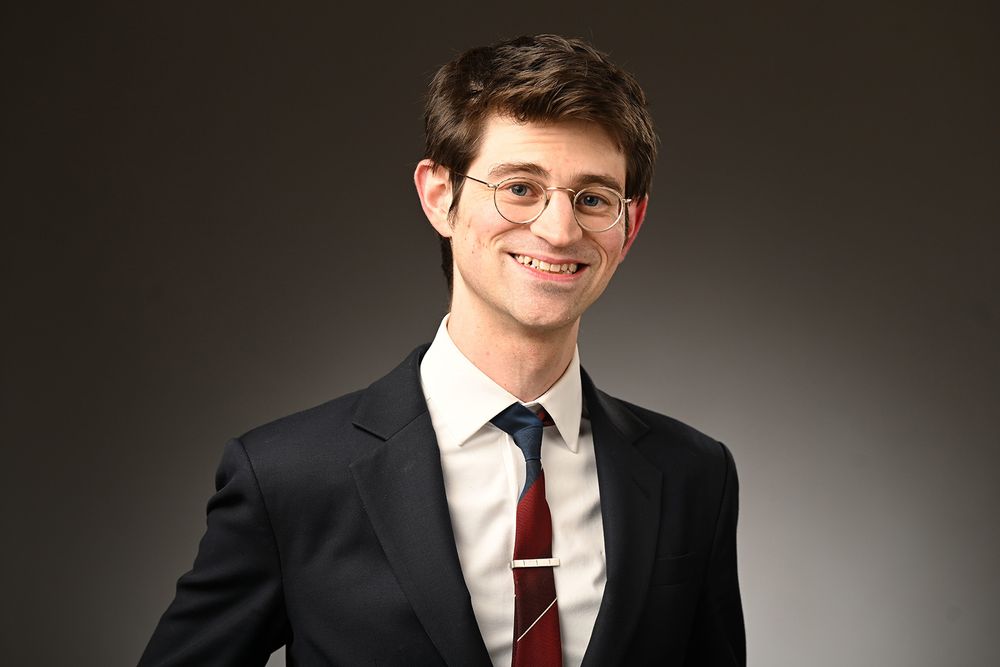 A man wearing a suit and eye glasses.