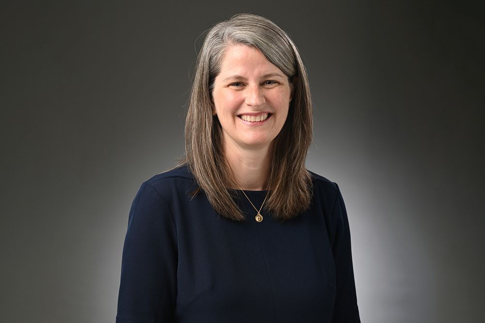 A woman wearing a dark sweater.