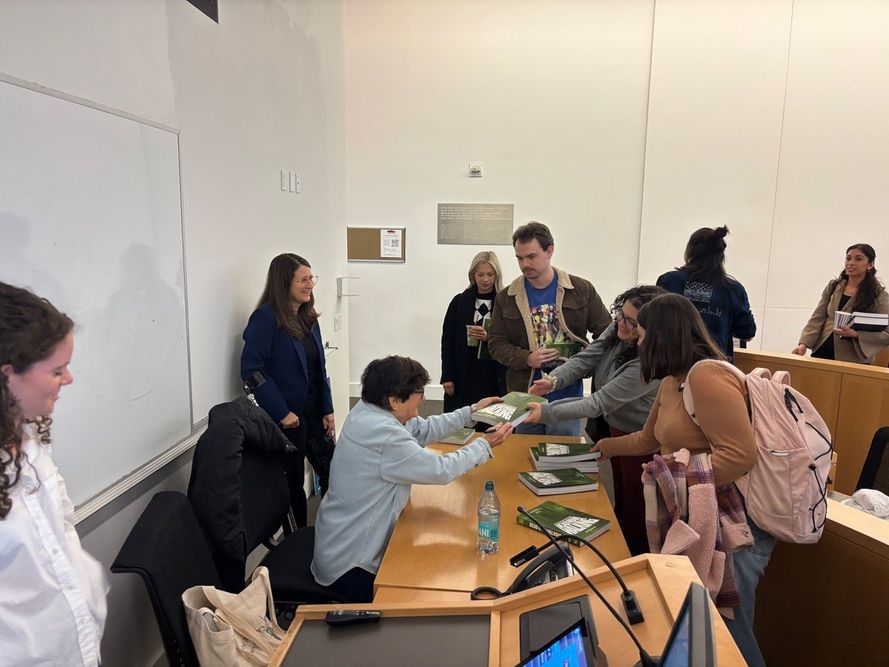 Sister Helen Prejean hands signed book Dead Man Walking to students