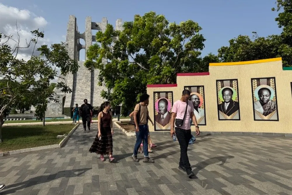 students walking in front of portraits
