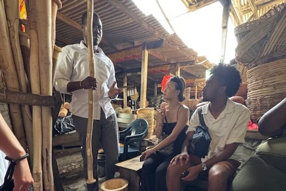 students in a market listening to a vendor
