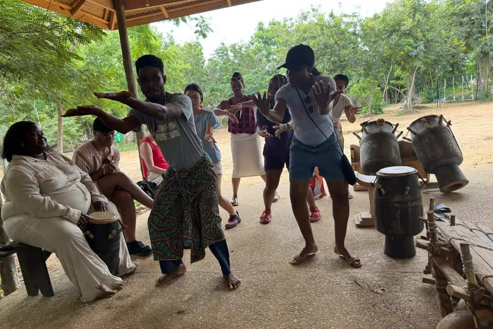 students standing and following the actions of a person
