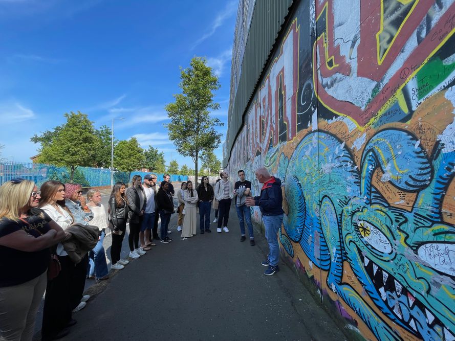 Fordham Law Ireland summer program 2023 students in front of graffiti wall