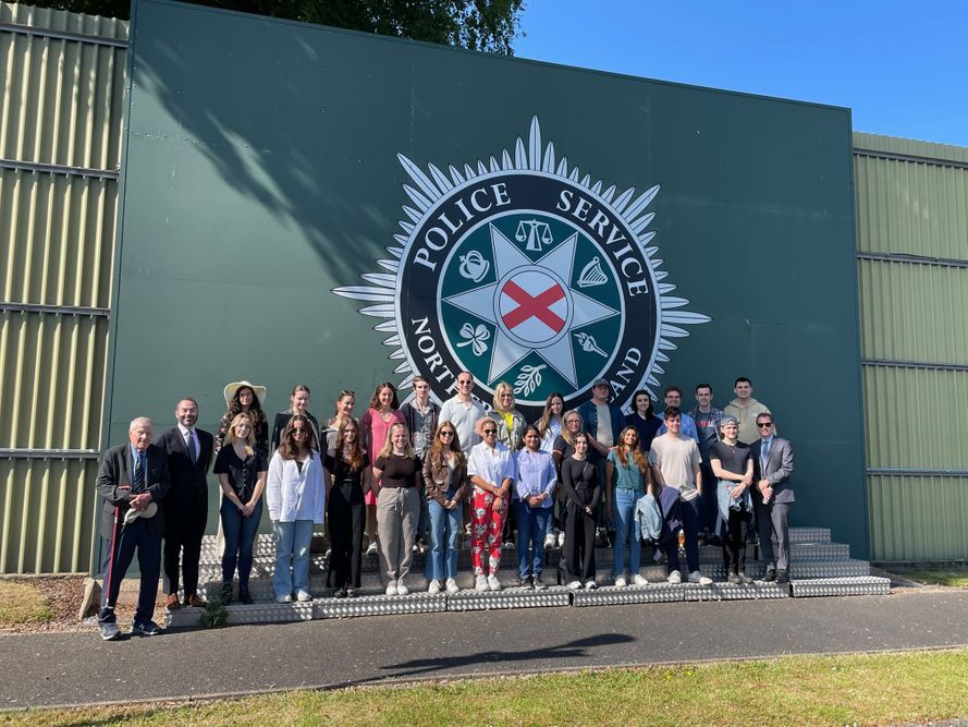 Fordham Law Ireland summer program 2023 students in front of police service wall