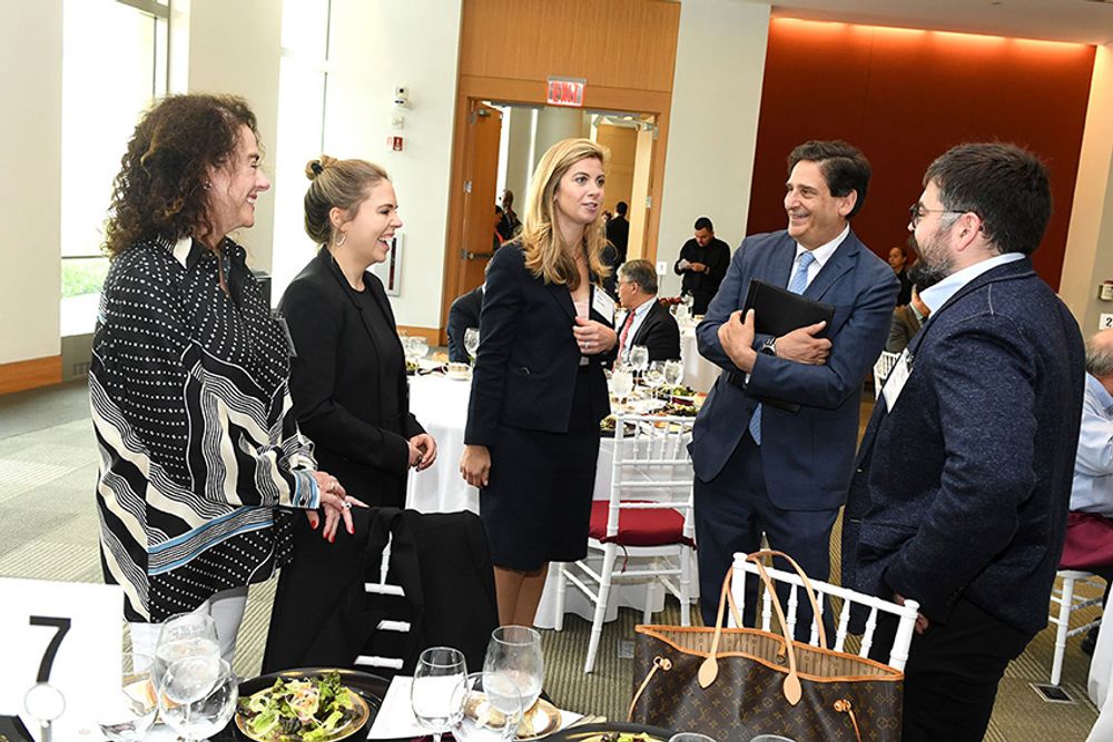 Kathleen Simpson, Caitlin Simpson, Amy Martella, Dean Diller, and Victor Simpson connect before the luncheon begins.