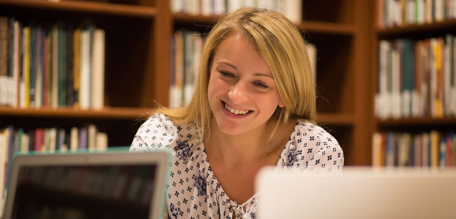 Female student studying in a library