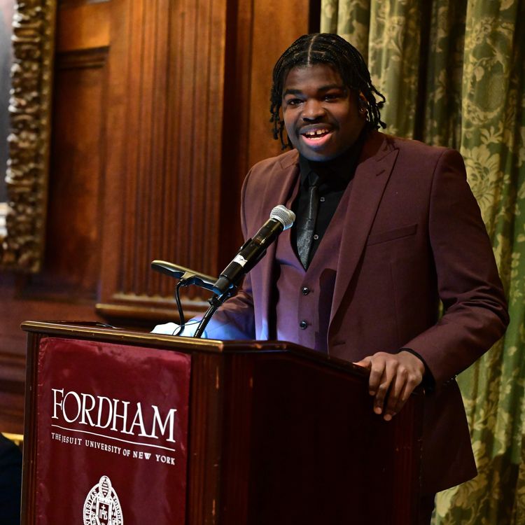male student speaking at podium