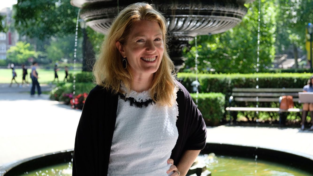 Photo of Vice Provost Elizabeth Rainey in front of a fountain on Fordham's Rose Hill campus