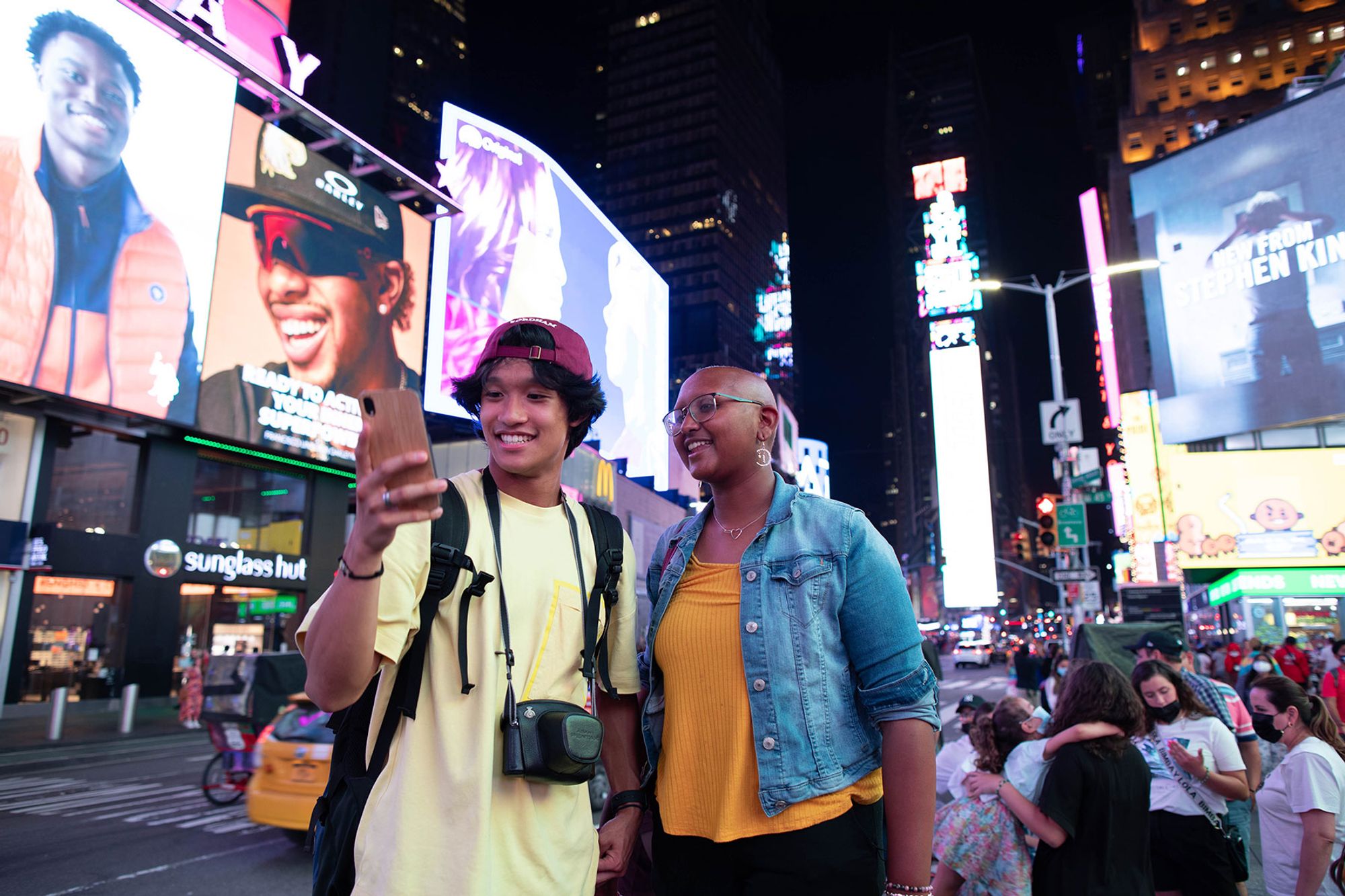 Fordham students look at a photo they took in Times Square