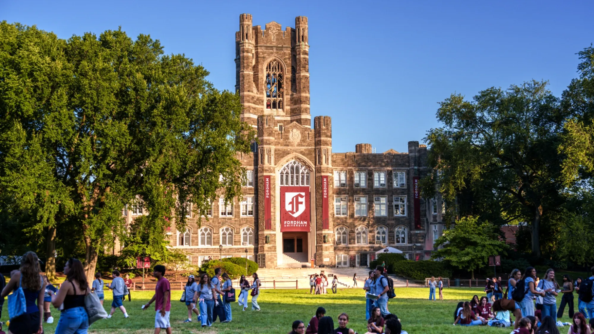 A photo of Fordham's Keating Hall with banners featuring the new branding