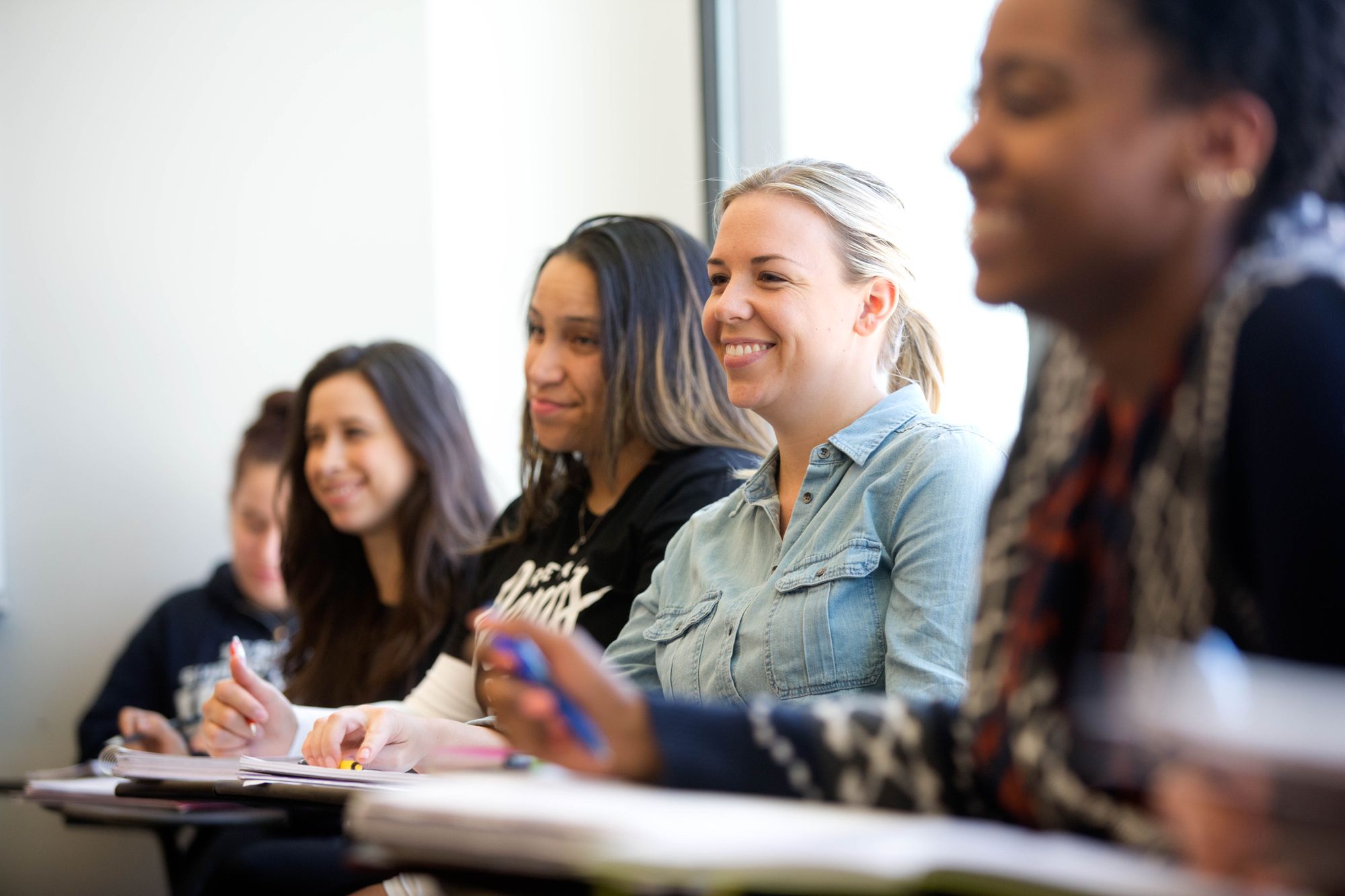 GSS students in a classroom, smiling and looking to the front of the room