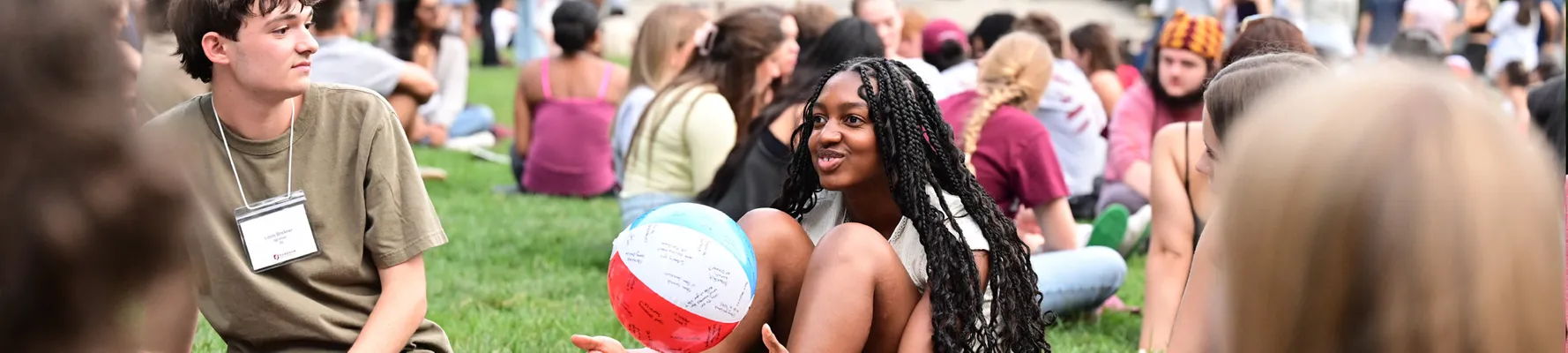 New students sitting on Edward's parade playing an ice breaker game