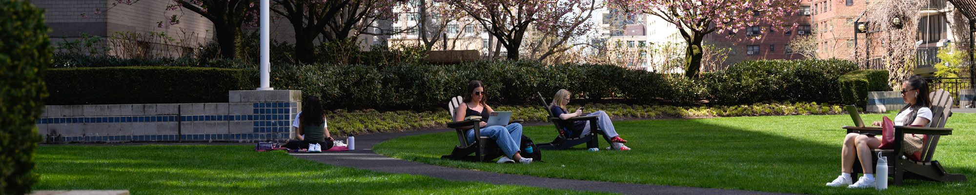 Fordham Students Sitting on Lawn Chairs on the Lincoln Center Plaza.