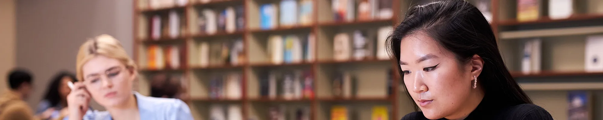Two students reading in library