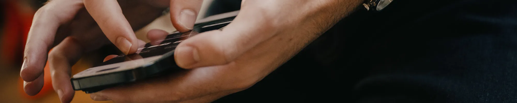 Male student using his smart phone