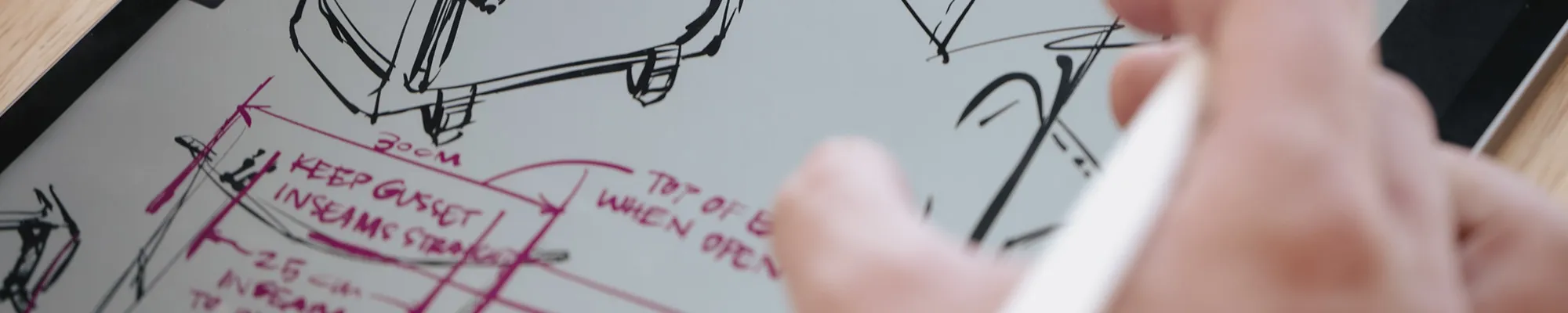 Close up of a student doing design work on a tablet