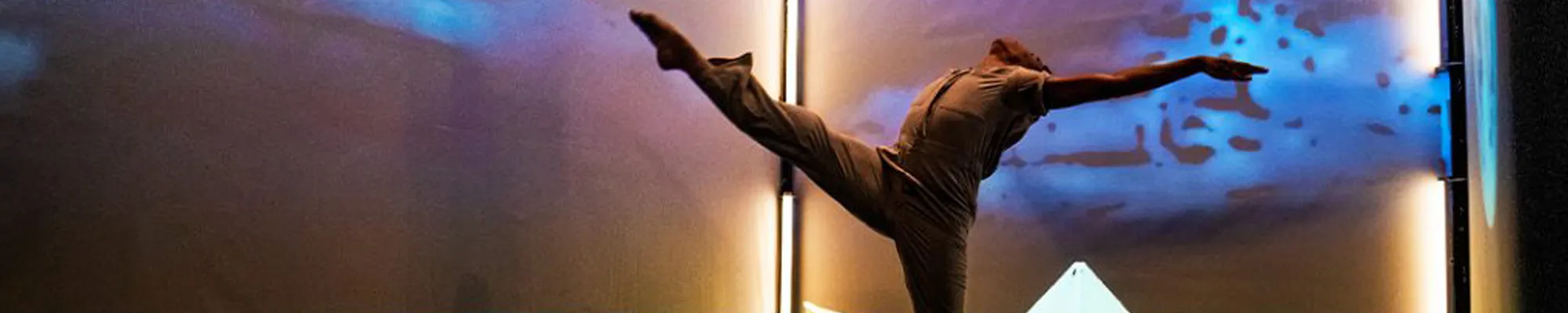 Dancer performing a leg kick on stage
