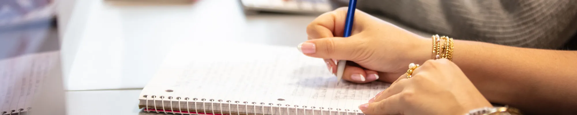 Female student writing in a spiral notebook
