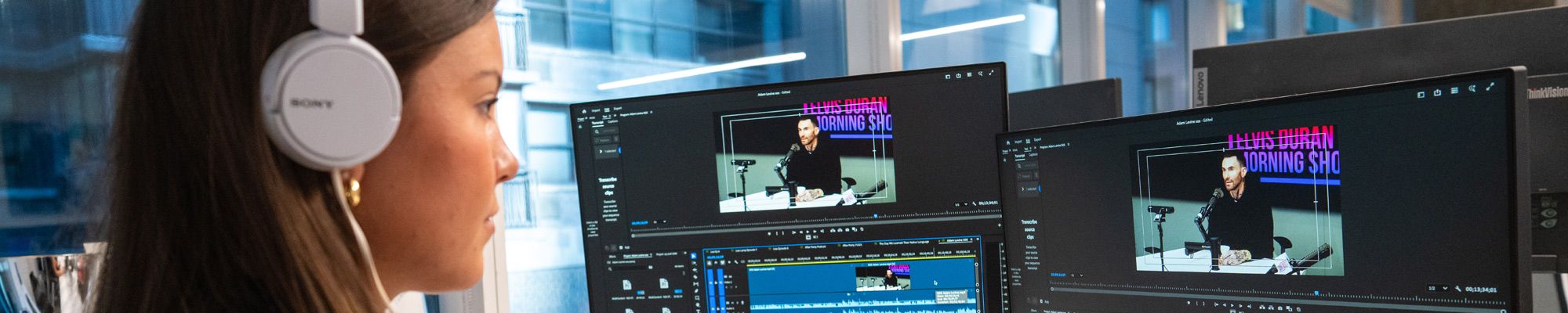 Female student editing a video segment in studio