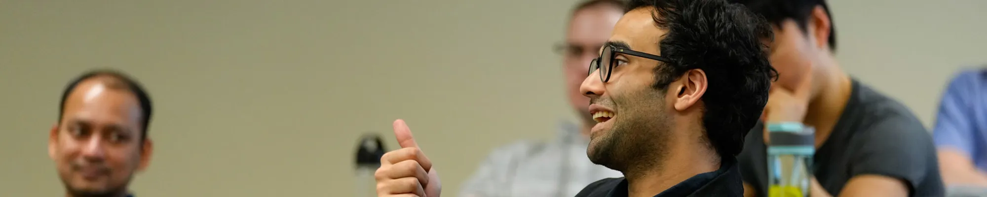 A male student speaking to the class