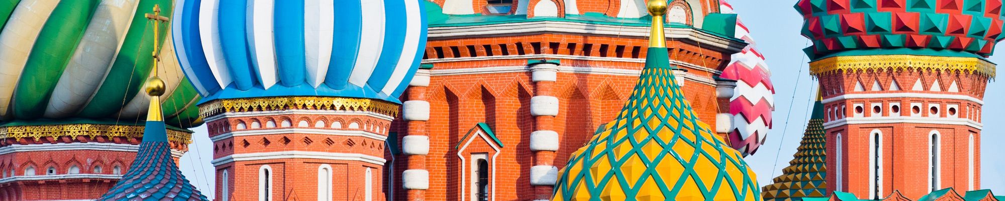 Domes of the Cathedral of Vasily the Blessed (Saint Basil's Cathedral)  against blue sky.
