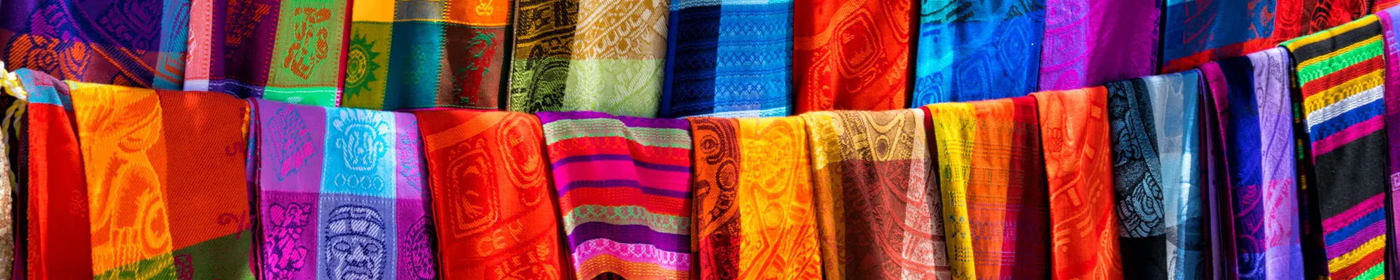 Many multicolored textiles being representative for the latin america culture and sold as souvenirs at chichen itza, yucatan mexico.