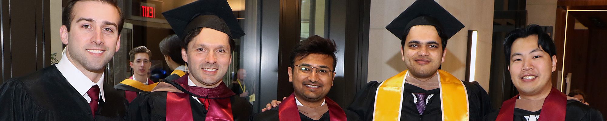 Graduates Posing at Graduate Diploma Ceremony