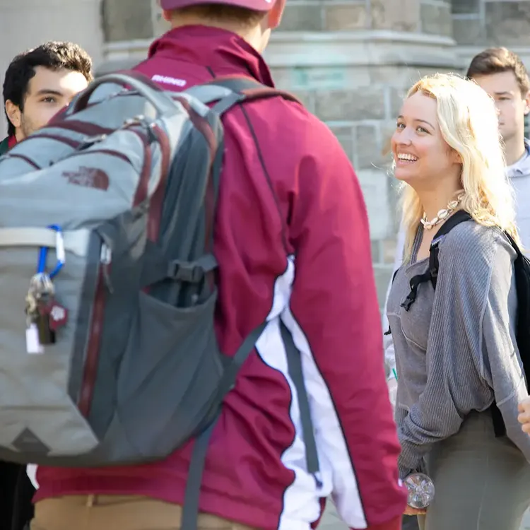 Students with backpacks chat