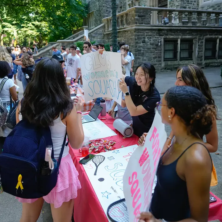 Club Fair table for Squash with several members holding up signs