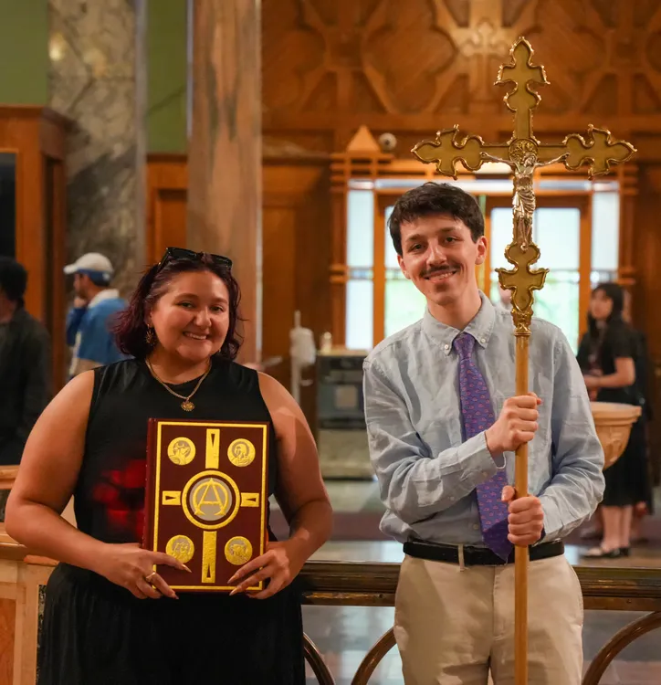 Student pose with bible and cross at LC.