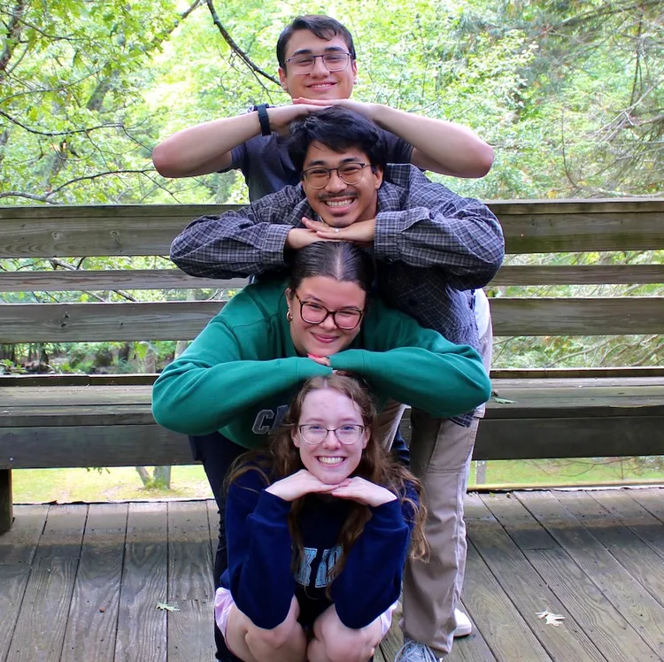 Students pose together in a stack on retreat