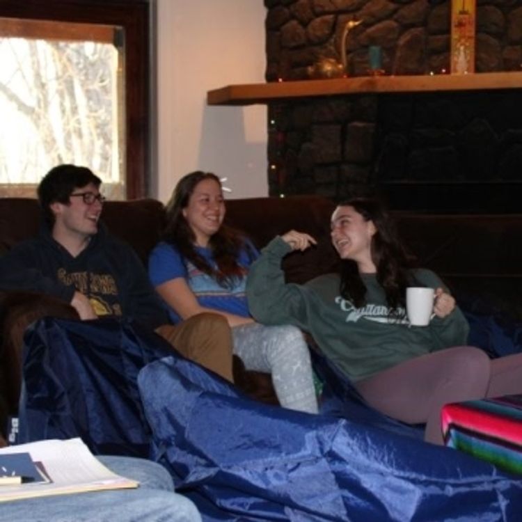 Three students talking to each other at retreat house in Goshen.