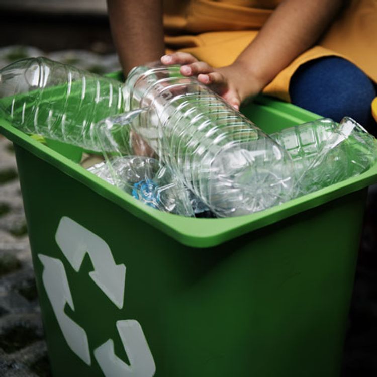A recycling bin full of empty plastic water bottles