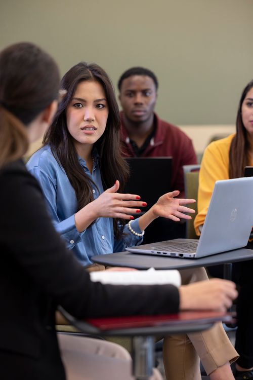 Students with laptops in classroom