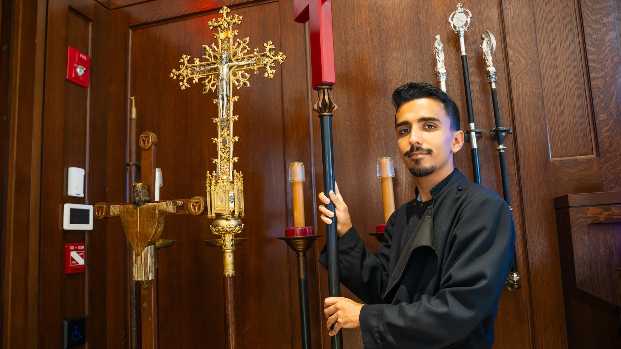 John Garza prepares the crucifix for mass at Trinity Church
