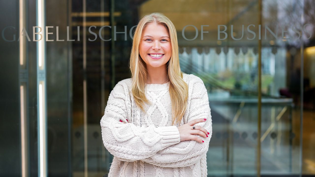 Julia Conroy stands in front of glass door