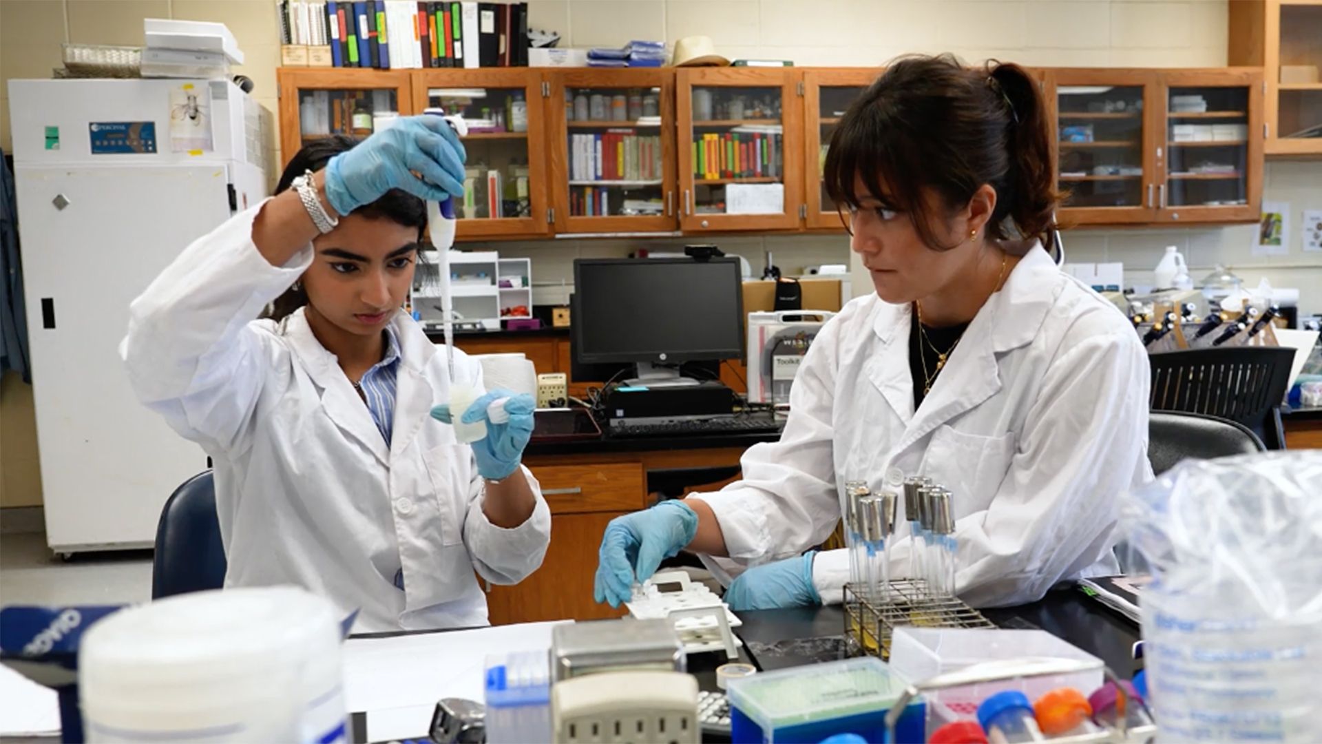 Two Fordham students in a lab studying Parkinson's disease by using fruit flies