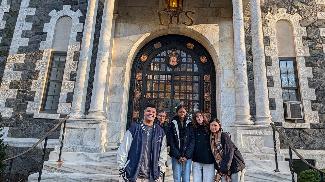 Christian Arrechea poses with local high students at Dealy Hall