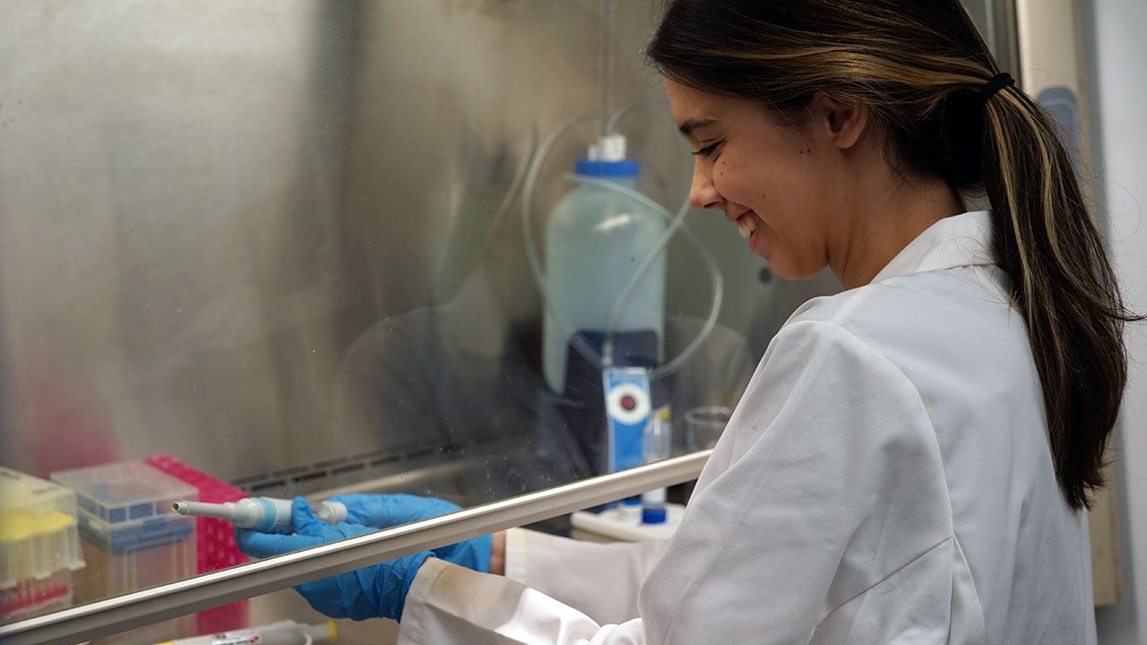 A student conducts research in a biochemistry lab