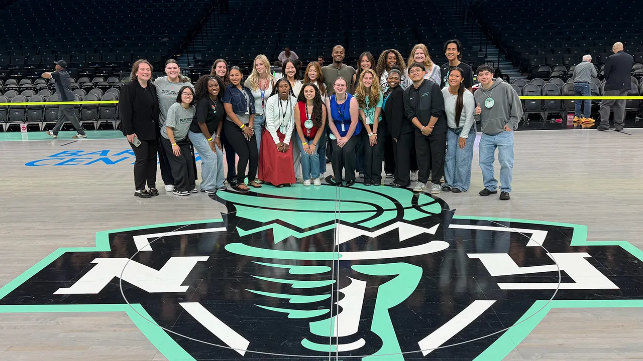 Patrick Gabriel Torres poses with his intern cohort on the floor of the Barclays Center